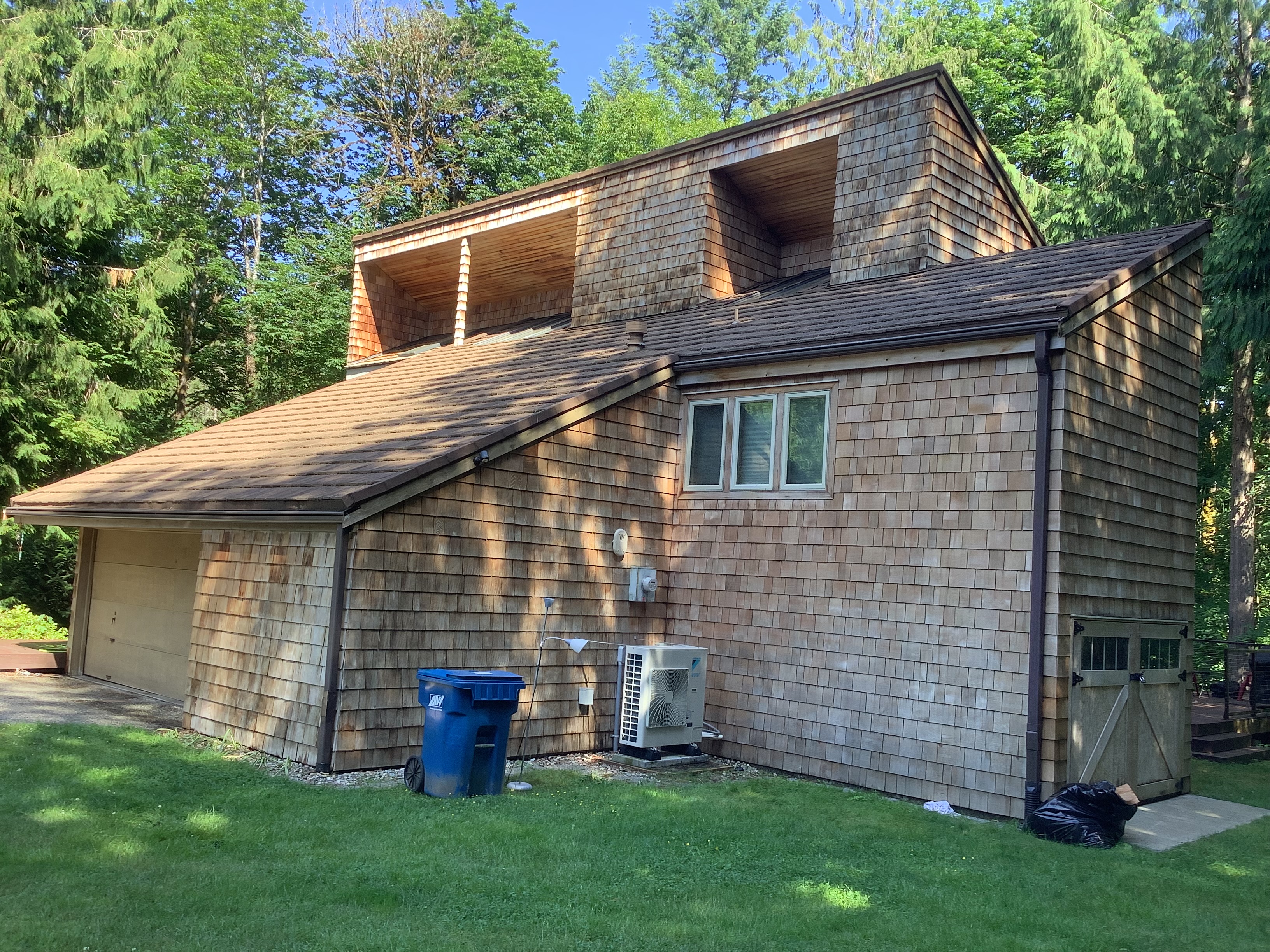 Weathered cedar shake siding on a two-story home before staining