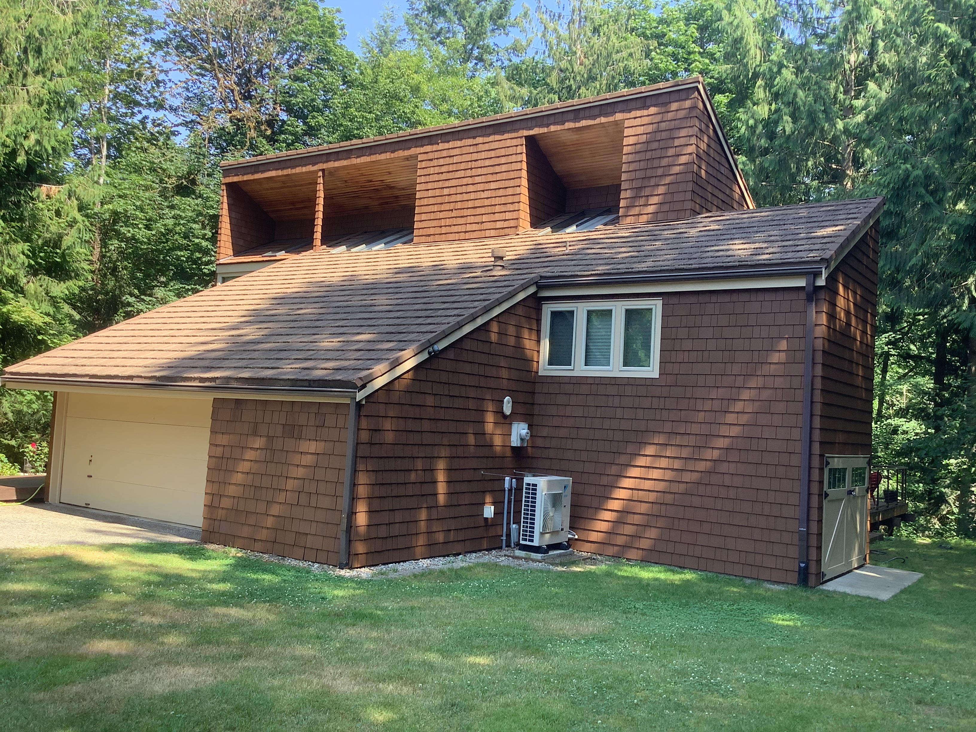Freshly stained brown cedar shake house and garage in the Seattle area