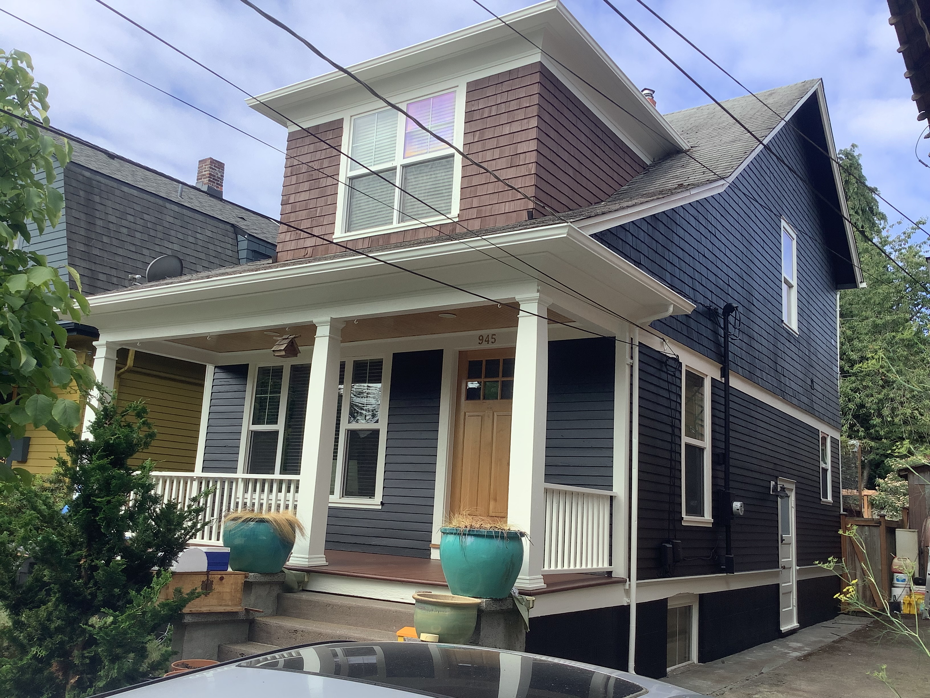 Navy exterior painting with brown shingles and a white porch in Seattle